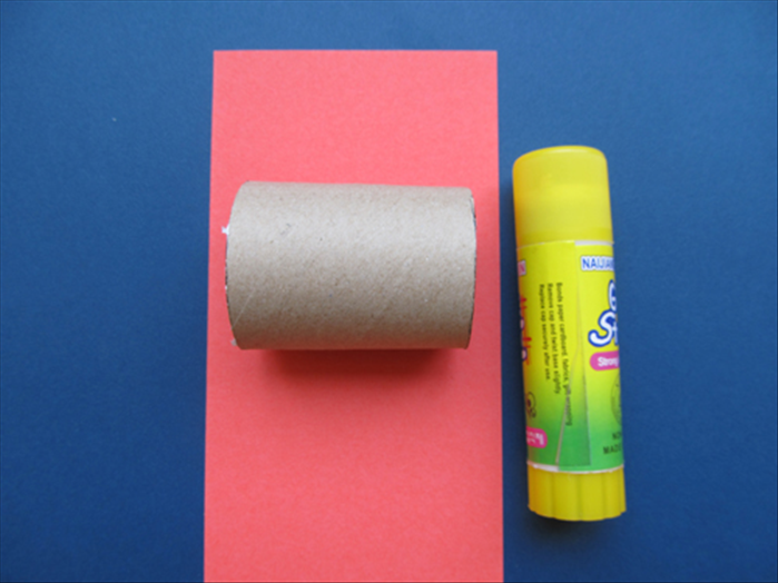 Cut a piece of colored paper big enough to go around the roll and 1 ½ inches wider than the roll
