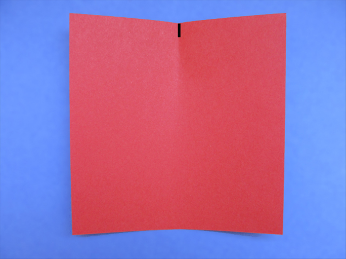 <p> Bring the right edge over to the left edge as if you were going to fold the paper in half. Do not crease it. Just pinch the edge to make a half way mark.</p> 
<p> *Short sides on top and bottom for rectangle paper</p>  
<p>  </p>