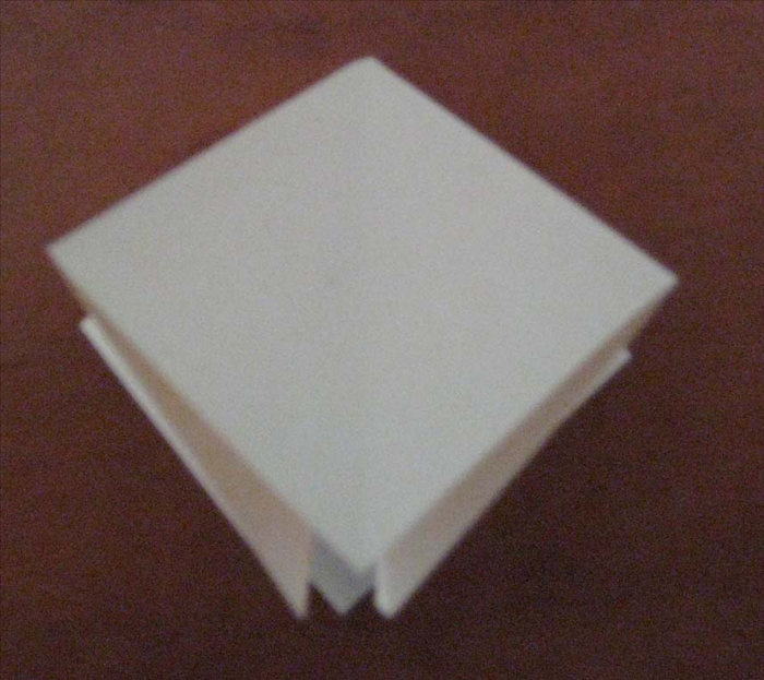 Press down to flatten and your origami square base is finished.