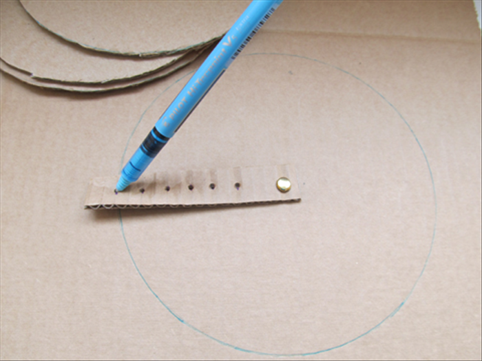 <p> Make a hole in the cardboard with the nail.</p> 
<p> Push the paper fastener through the 1 st hole and the hole in the cardboard.</p> 
<p> Fasten it in the back.</p> 
<p> Put the pen point in the last hole and rotate the strip to draw a circle.</p> 
<p> This is the largest circle and the base of the tree.</p> 
<p> Make 3 more. Cut out all 4 circles.</p> 
<p>  </p>