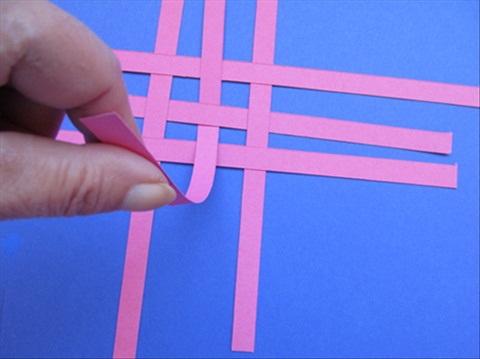 Lift the bottom of the center strip, slide in another strip and glue as you did in the last step.