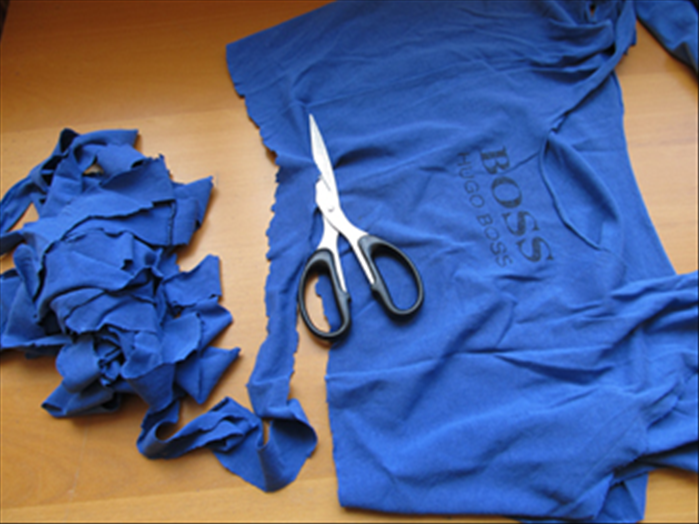 Cut a long continuous strip from the bottom of the tee shirt until you get to the bottom of the sleeves.