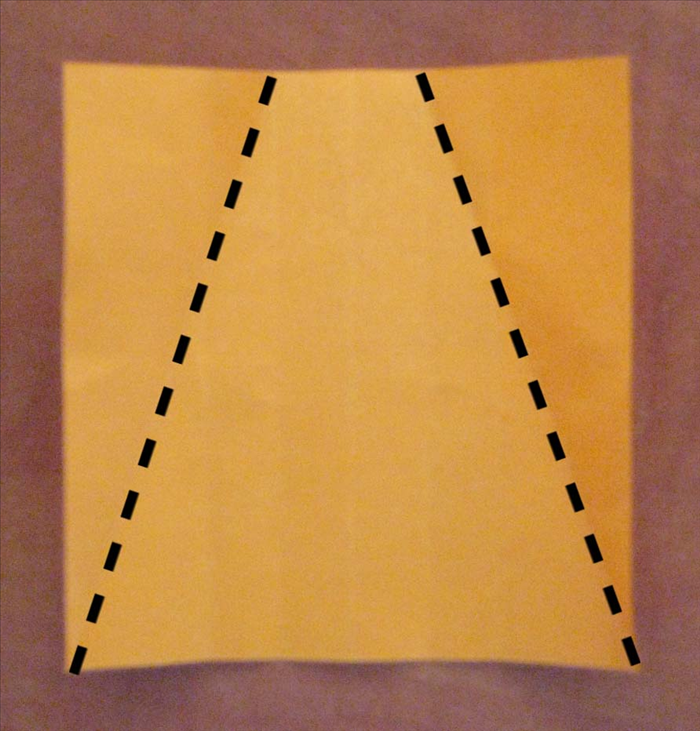 Rotate the paper so that the creases are from top to bottom.

Fold from top of the crease to the right of the center at an angle to the bottom right edge. Unfold

Fold from top of the crease to the left of the center at an angle to the left bottom edge. Refold the right side.