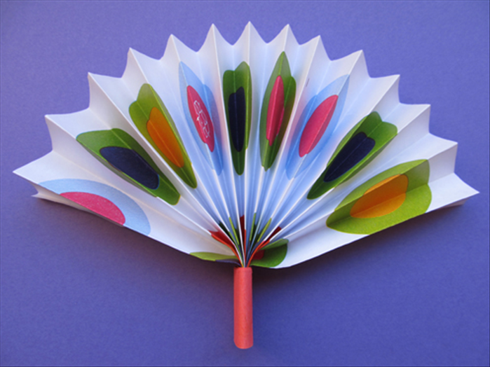 Pull down the ends of the folded paper.

Your fan is ready to cool you off!
