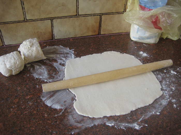 Divide the dough into 3 equal balls
Roll one of the balls out onto a floured surface
