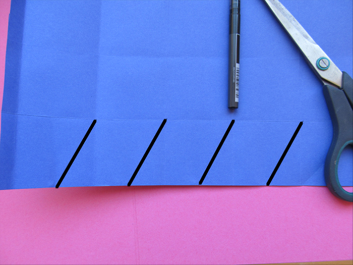 Use a ruler or straight edge to make a straight line from the pinch marks  to the top right side of the 4 squares.

Cut a slit alone those lines.

