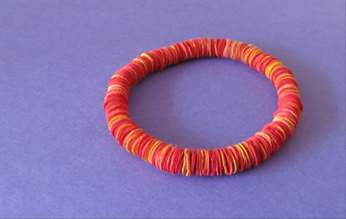 Materials:
Scrap paper
Hole puncher
Elastic string for the bracelet or strong string for the  necklace
Needle
a small piece of corrugated cardboard
