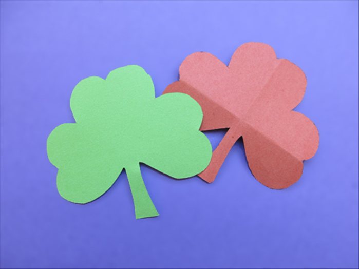 Materials:
1 square paper for the finished shamrock
2 squares of scrap paper the same size
Scissors
Pen or pencil
