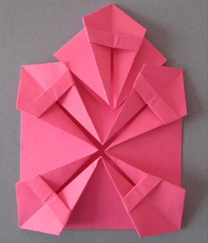 Insert one small piece so that it’s wings slide under  the top layer of the 2 “kites” on the large paper