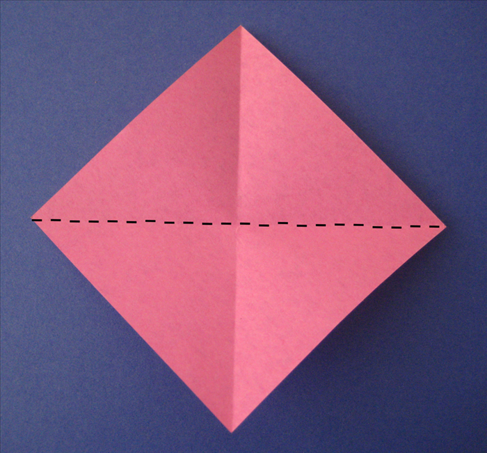 Rotate the paper and fold it diagonally in the opposite direction