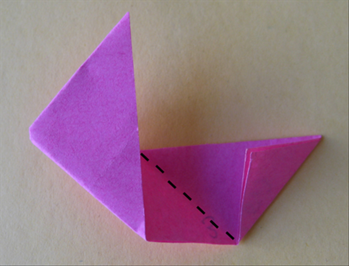 <p> Fold the right side down to the center crease so that it aligns with the flap you just made.</p>