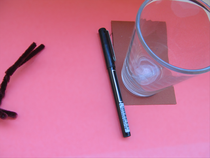 Fold a paper in half.
Trace the outline of a glass or round object
*Leave room on top for the next step
