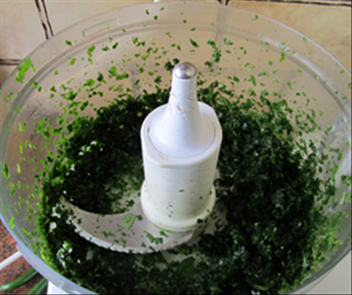 Add the coriander in the mixer and run for about a minute or until all the leaves are chopped to tiny pieces.