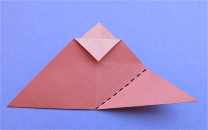 Starting from the bottom center, fold the right bottom edge up to the right side of  the triangle flap you just created.