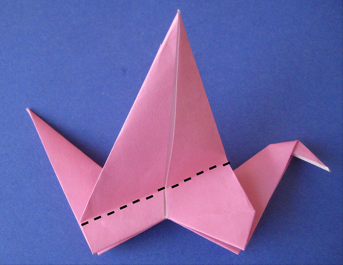 Fold the wing down at an angle.

Flip the paper over and fold down the other wing to match.

Pull the wings up.
