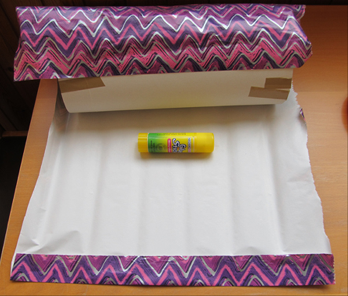 Remove the tube from the lids.
Glue one end of your wrapping paper or wall paper to the tube.
Make a fold at the other end of the paper to have a neat edge.
