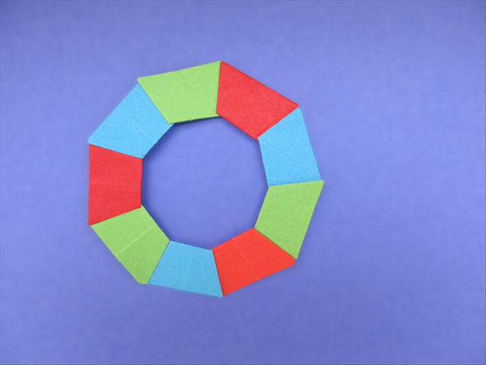 <p> Glue all the remaining pieces using the same color order.</p> 
<p> Enjoy your origami wreath!</p>