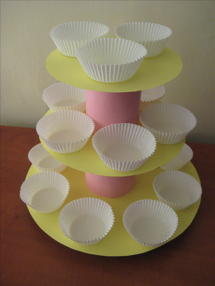 Materials:
Cardboard
Circular items for templates such as a large serving tray and dishes
2 full cans of food – the food provides weight and makes the tower stable
Decorative or wrapping paper
Pen, scissors, scotch tape, paper glue stick
