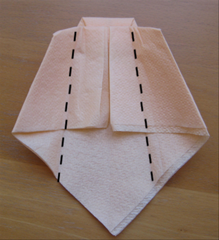 Flip the napkin over to the back side.

Fold the sides to the center and align them.