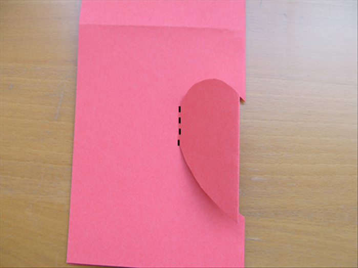 Fold the half - heart  shape to the left along the area you did not cut.