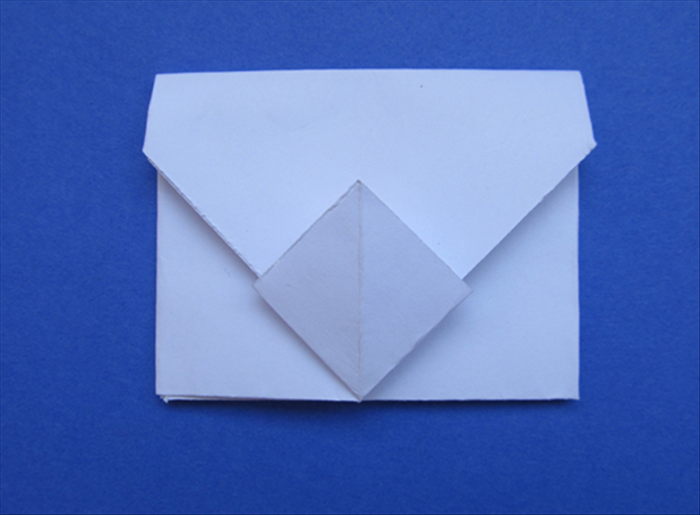 Push it in as far as it will go and crease the top.
Your origami envelope is finished!
