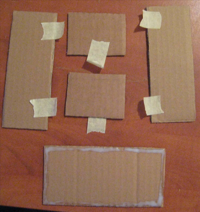 <p> Spread glue around the edges of the largest rectangle. Put masking tape on all the other rectangles. Put glue on the 2 shortest edges of the 2 smallest rectangles. Place the long edges of the taped rectangles onto the glue. Align all the edges and use the tape to hold them in place until the glue dries completely.</p>