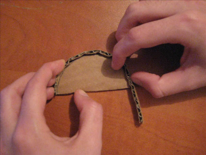 <p> Use a thin cardboard strip to measure the rounded top. Cut off the extra part.</p>