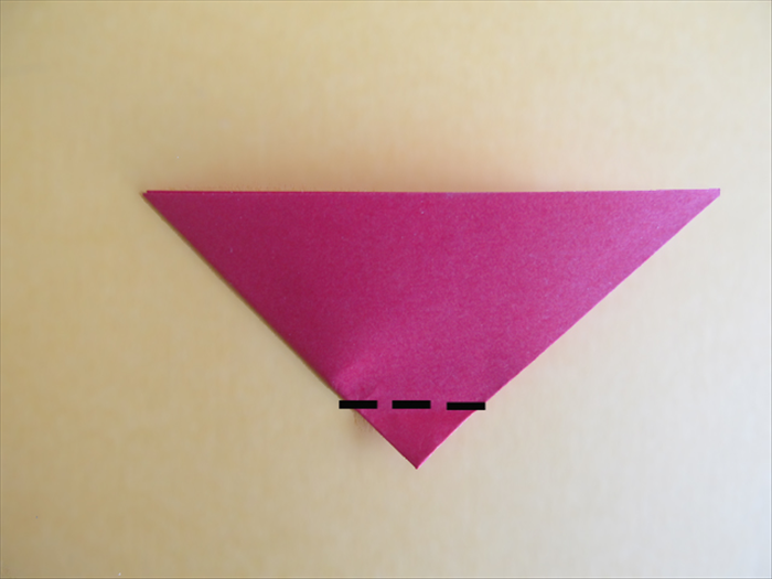 <p> Rotate the paper so that the long end is on the top.</p> 
<p> Make a very small fold on the bottom tip.</p> 
<p>  </p>