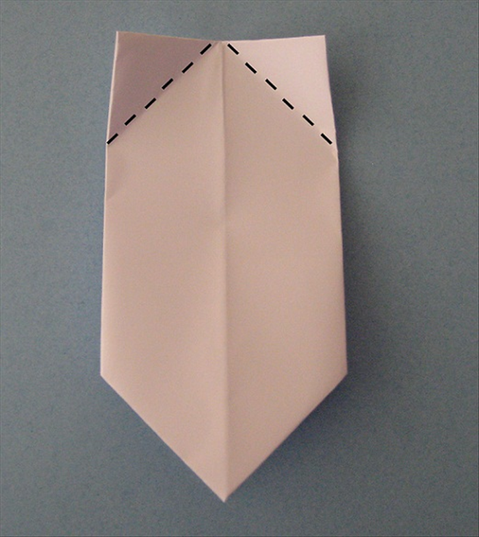 Place the paper with the folded edge at the top.

Fold the 2 corners down to align with the center crease.
Unfold.