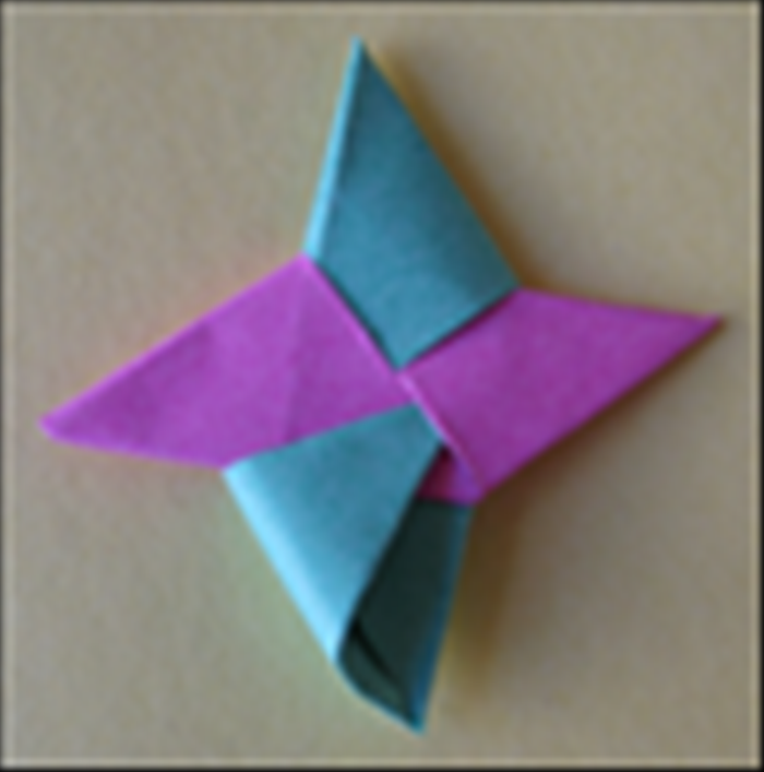 <p> and tuck it into the flap as shown in the picture. Push it in all the way and your throwing star is ready!</p>