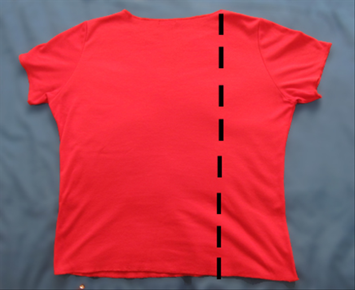 Spread the tee shirt with the front facing down
Fold the right side from the right edge of the neckline
