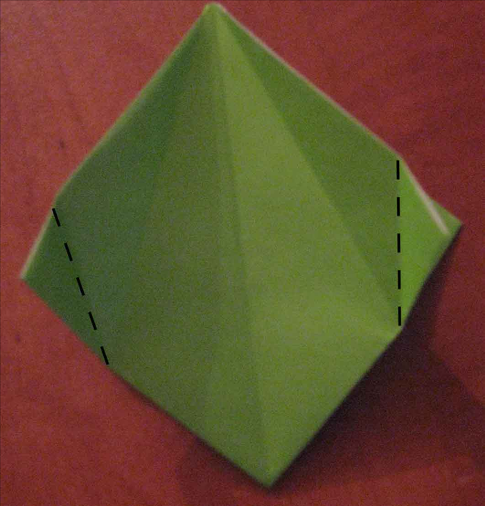 Fold the 2 side points horizontally from the bottom of the crease you just made in the last step.
Unfold