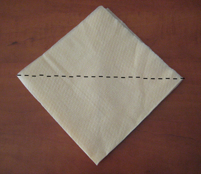 Flip the napkin over to the back side.
The open edge should be on the top.

Fold the bottom point up to the top point.