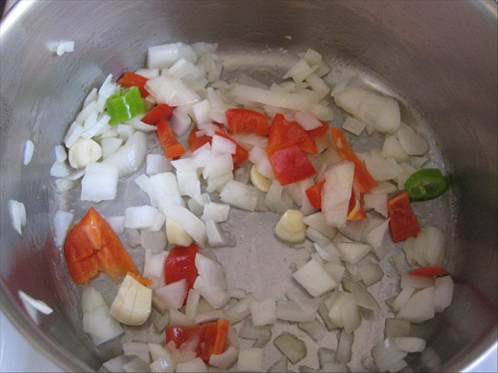 Sauté the onions, garlic, peppers until the onions are translucent