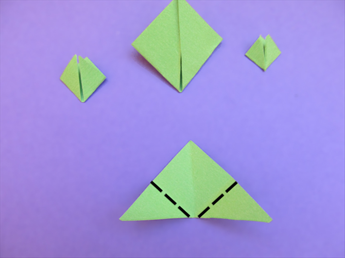 Fold the bottom points of the 4 triangles up to the top point.
Put the 4 folded triangles aside.

