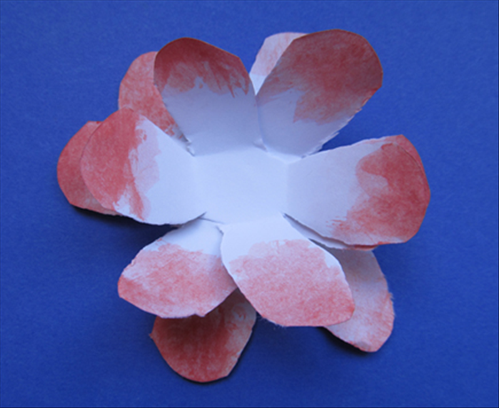 Fold the top 2 layers of petals upwards. 
Flip over the flower and fold the bottom layer upwards to make it folded in the opposite direction.

This is a finished flower.
Now make lots more