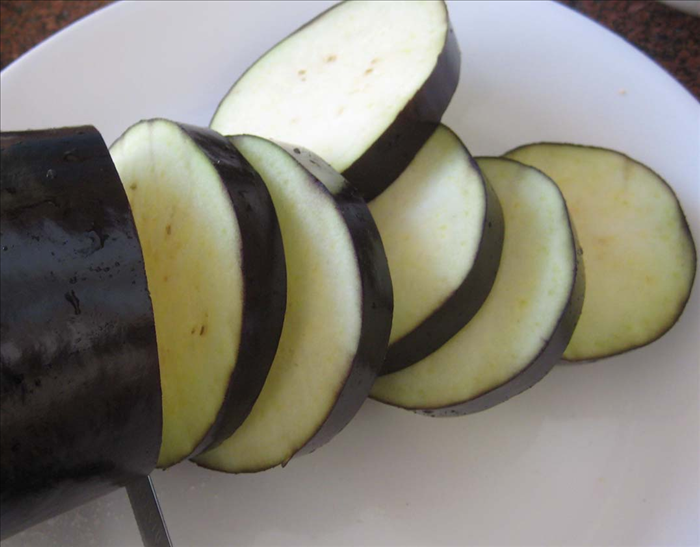Slice the eggplant into about  ¼ inch slices