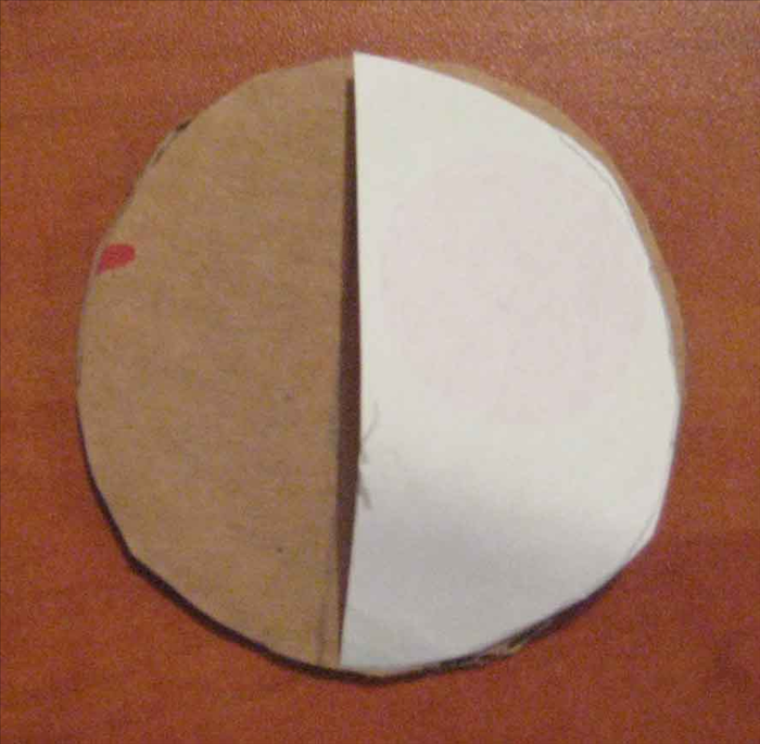 <p> Use the same circular object to trace and cut out a circle from paper. Fold the paper circle in half. Place it onto the cardboard circle and use the straight edge to mark a line going across the middle. Cut the cardboard in half.</p>