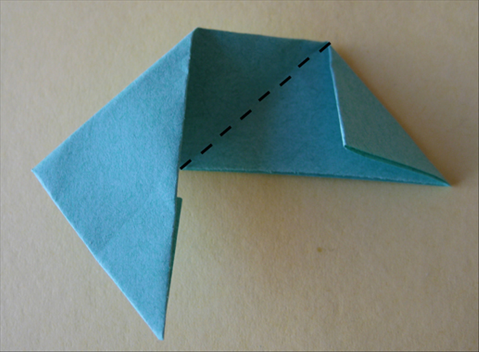 <p> Fold the right side up at the center crease so that it aligns with the flap you just made.</p>