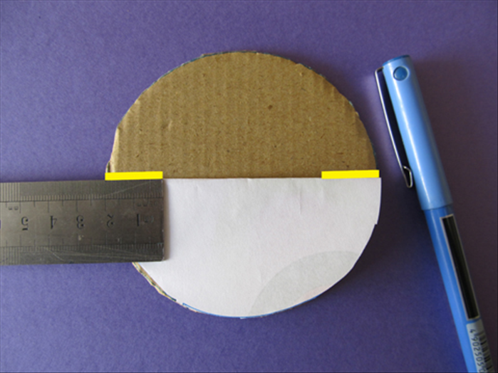 Fold the paper circle in half
Align it to the edge
Mark a ¾ inch long line at each end
