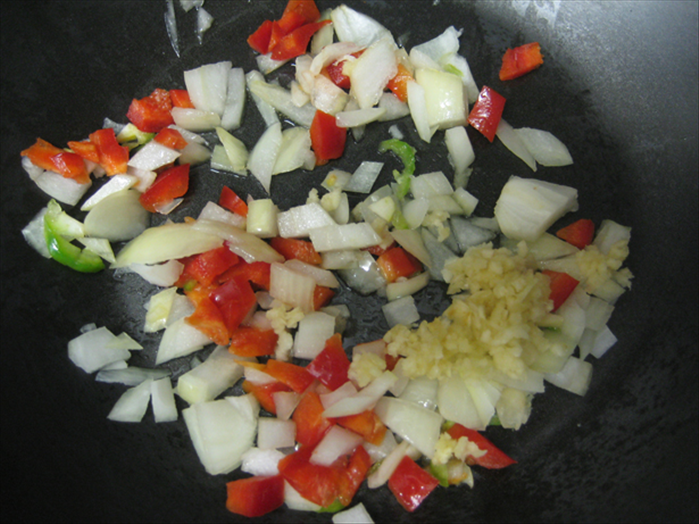 Fry the onion in 2 tablespoons oil until translucent 
add the garlic and peppers (if you want peppers in your sauce)
and fry another minute
