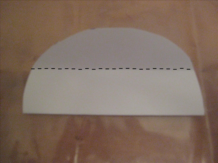 Bring the bottom edge up to the top to fold the circle in half again