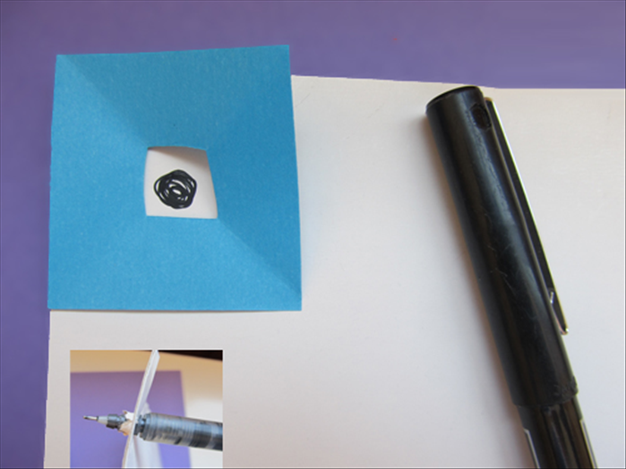 Align the extra square to the corner of the cardboard
mark the center.
Pierce a hole with a pen point. Make the hole big enough for a paper roll to go through.
