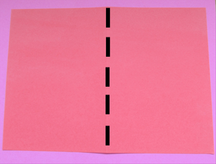 Place the 2 large papers on the table with the short ends at the sides

Fold them both in half by bringing the sides together