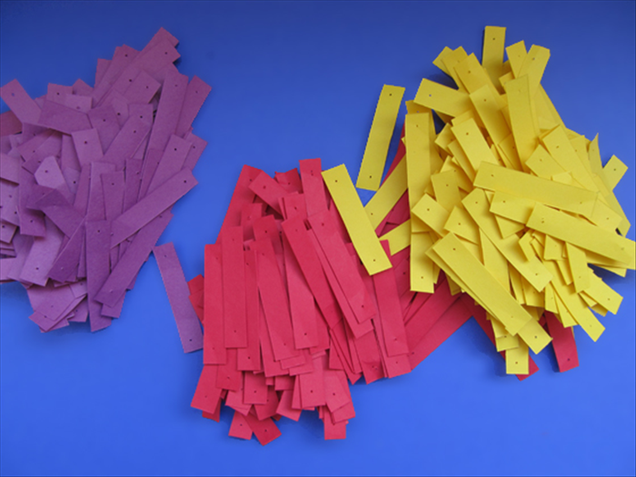 <p> Punch holes in all the paper strips.</p> 
<p>  </p>