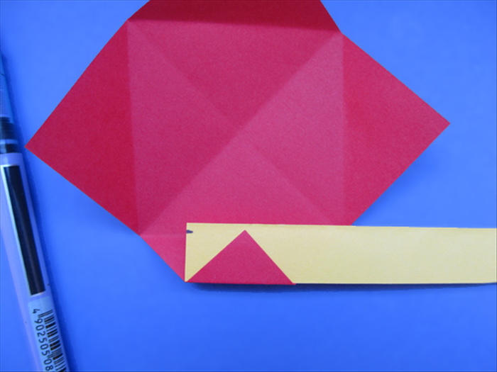 <p> The width you need for the paper strip is measured from the bottom of the triangle to the crease of the square.</p> 
<p> Put the paper strip under the triangle and mark where the crease is.</p> 
<p> Cut the whole strip the width that you measured.</p> 
<p>  </p>