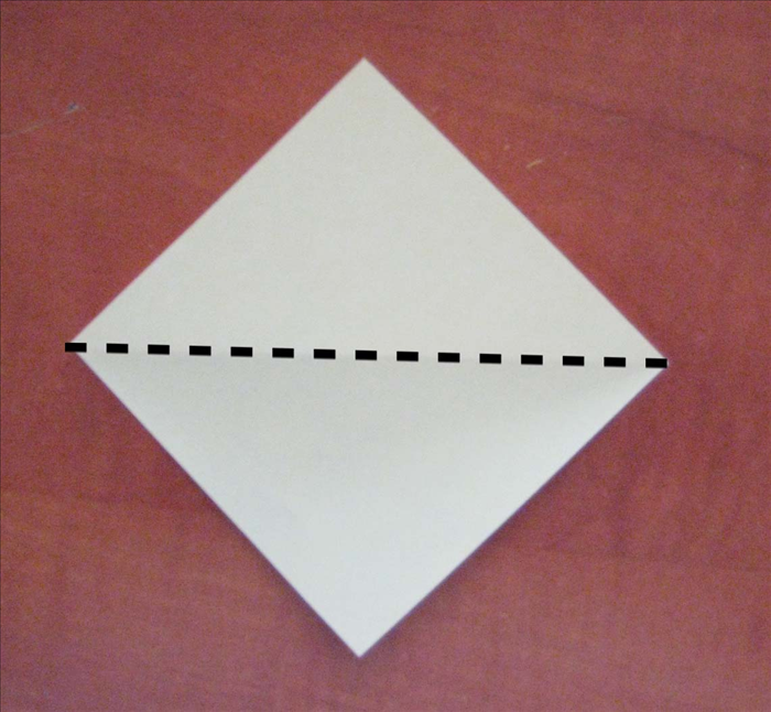 Place the paper with the points at the top, bottom and sides.

Bring the top point down to the bottom point to fold in half.