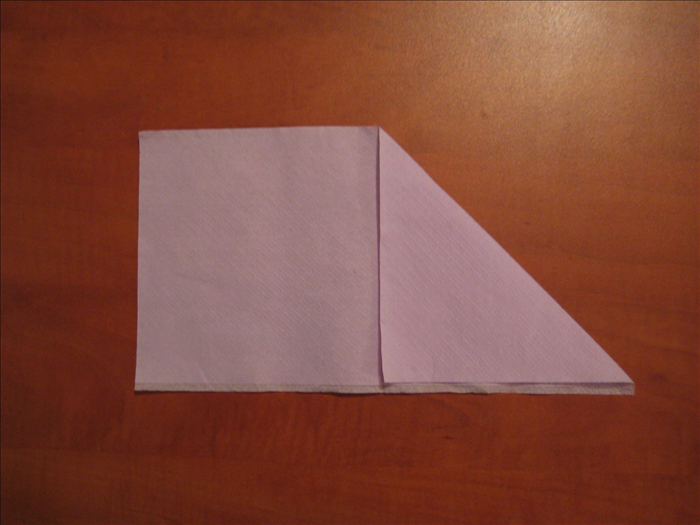 Bring the right upper corner down to the bottom  middle of the napkin.