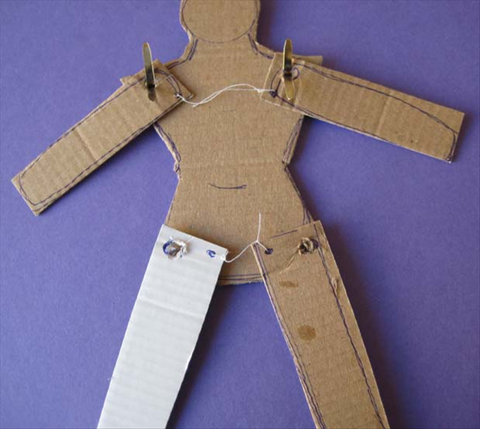 knot a string at each dot of the legs.
Put paper fasteners from the torso through the legs.
.
