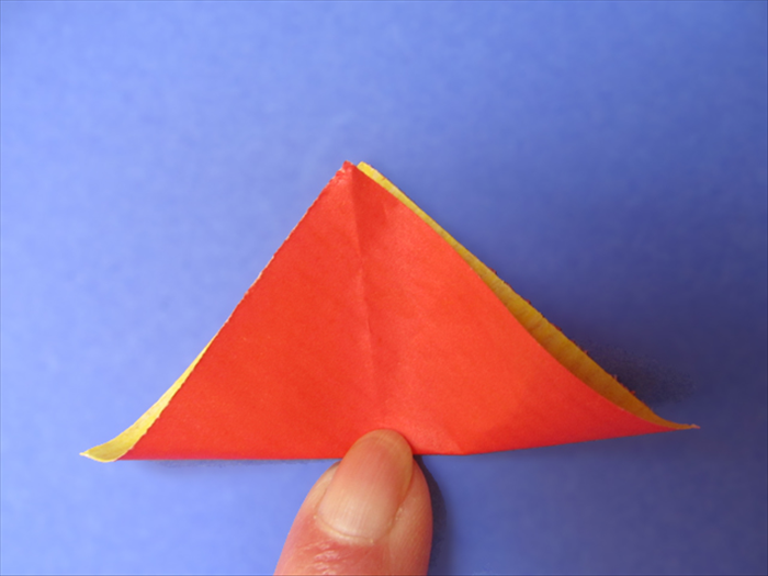 <p> Bring the bottom point up to the top as if you were going to carefully fold it in half.</p> 
<p> Do not fold it. Pinch at the center.</p> 
<p> Unfold</p> 
<p>  </p>